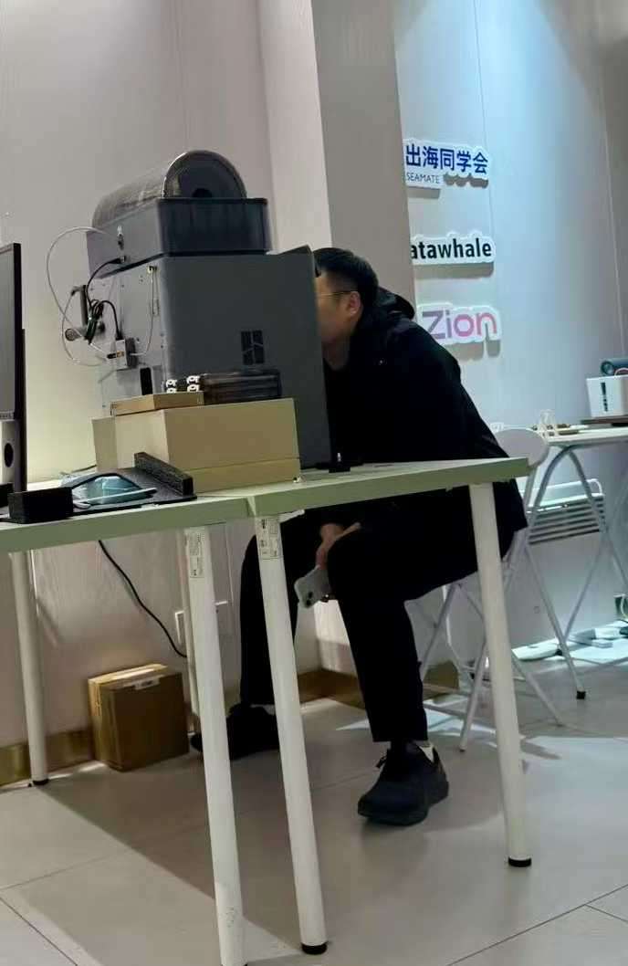 在工作桌旁观察 3D 打印设备
